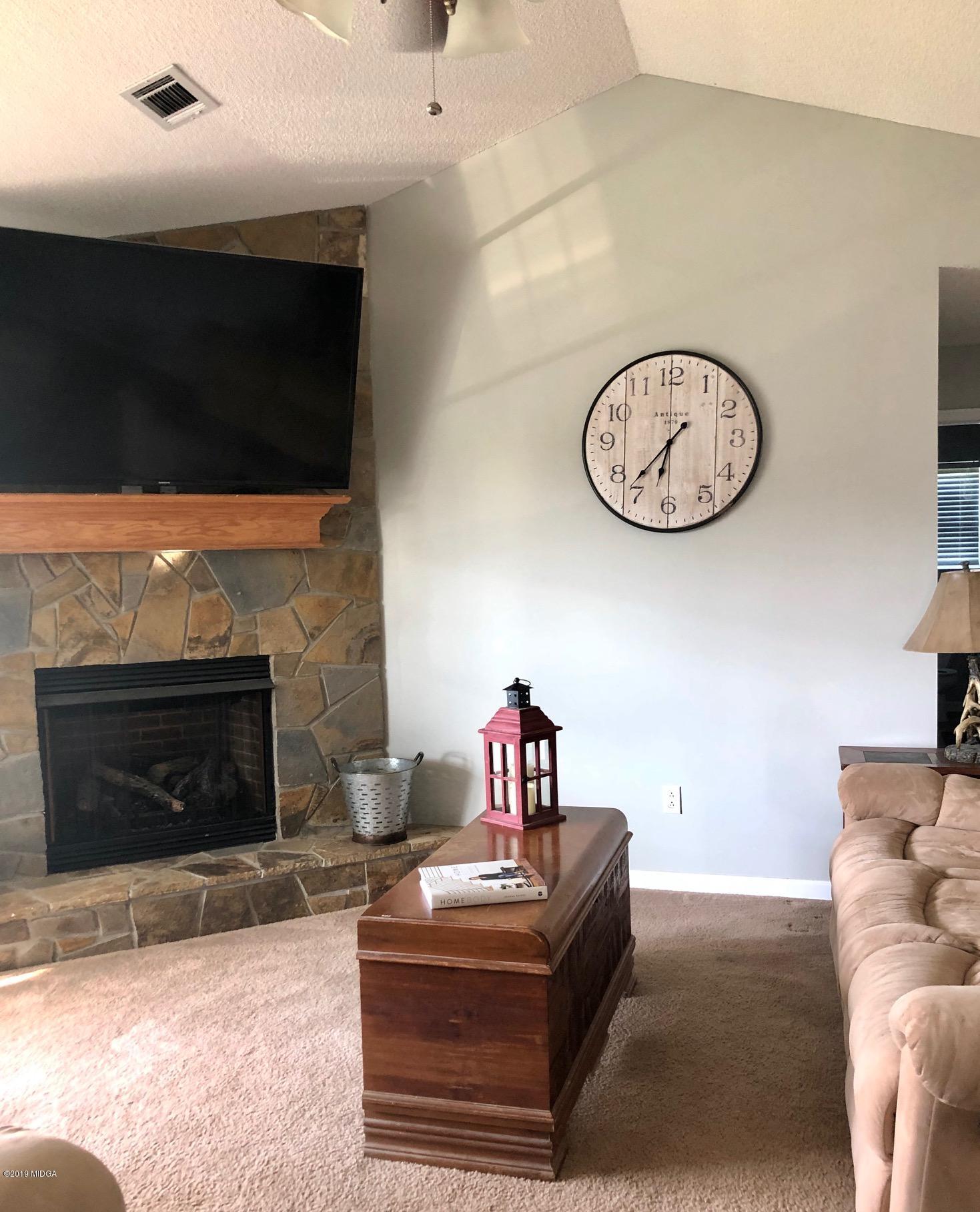 445 Childs Road Roberta, GA 31078 - Photo 9 of 23 a living room with furniture a fireplace and a flat screen tv