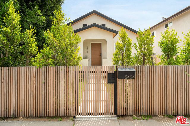 a front view of a house with a iron gate