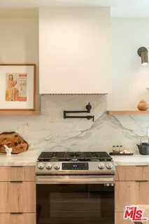 a stove top oven sitting inside of a kitchen