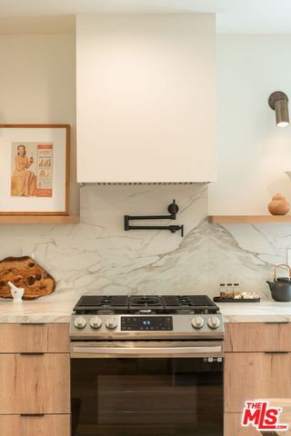 a stove top oven sitting inside of a kitchen