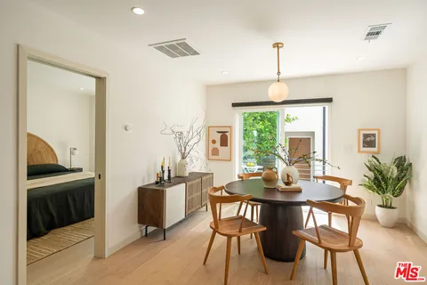 a dining room with furniture window and wooden floor