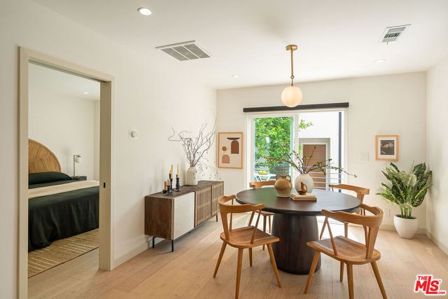 a dining room with furniture window and wooden floor