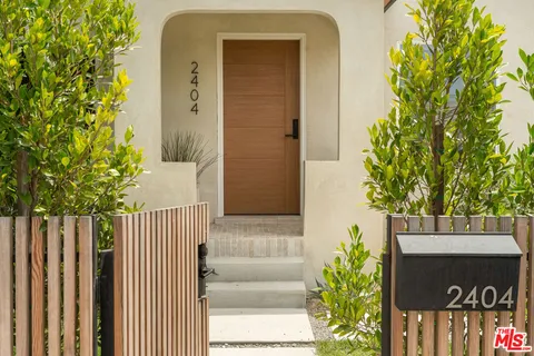a front view of a house with a tree