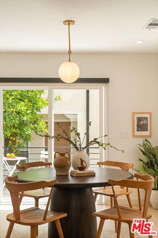 a view of a dining room with furniture wooden floor and a chandelier