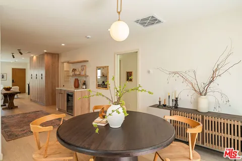 a dining room with furniture and wooden floor