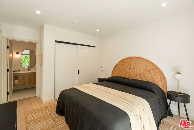 a bedroom with a bed and a view of bathroom