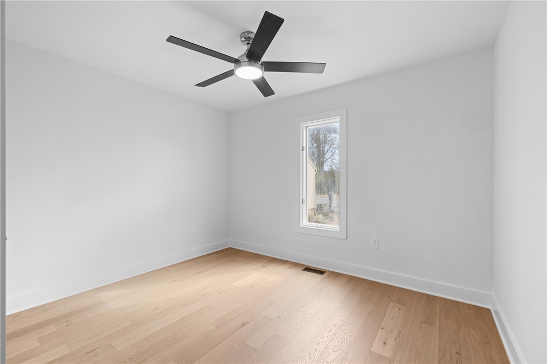 117 Riverpoint Drive Clemson, SC 29631 - Photo 30 of 47 This airy room features light wood flooring and a modern ceiling fan, offering comfort and style.