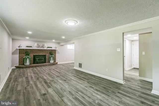 wooden floor in an empty room with a fireplace