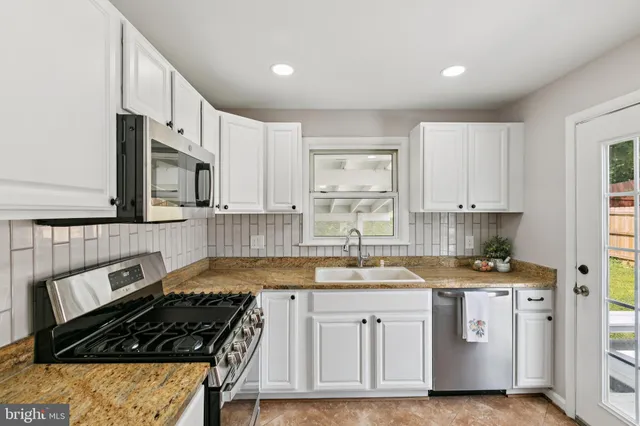 a kitchen that has a sink and a stove