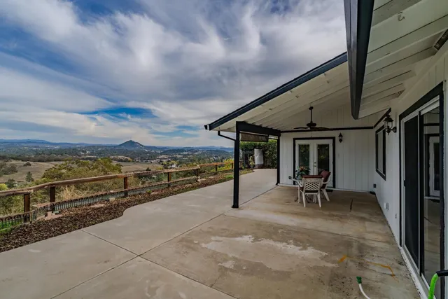 a view of a balcony with furniture and a floor to ceiling window