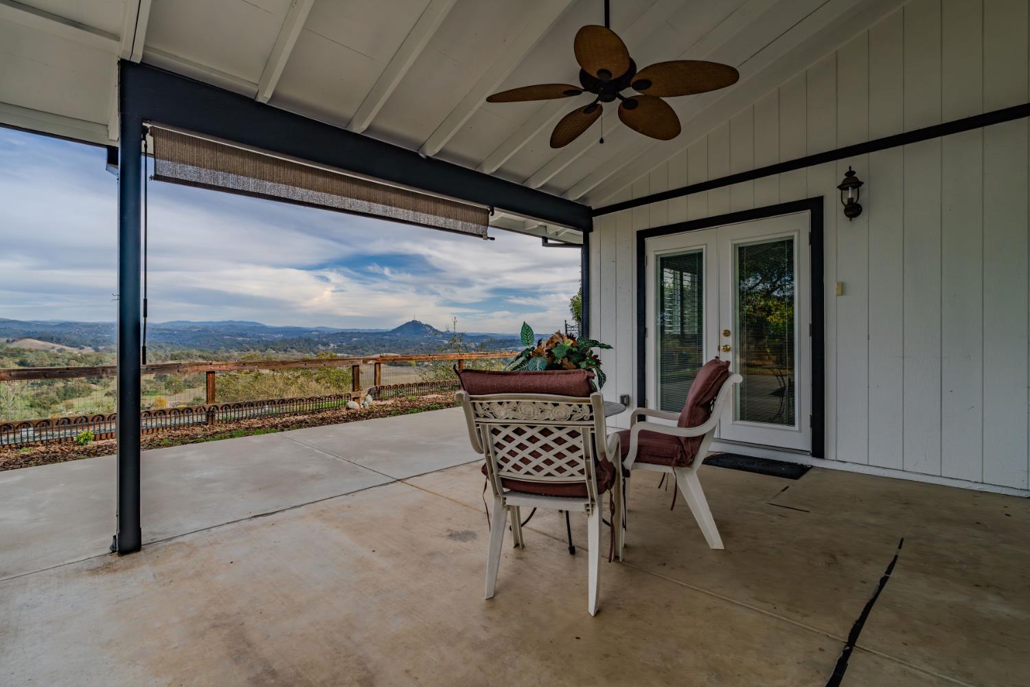 10370 Spunn Road Jackson, CA 95642 - Photo 23 of 87 a view of a patio with a table chairs and a floor to ceiling window