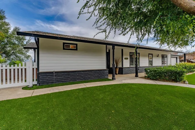 a kitchen with kitchen island granite countertop a sink cabinets and wooden floor