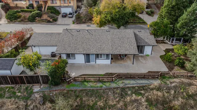 a kitchen with stainless steel appliances granite countertop white cabinets and a stove top oven