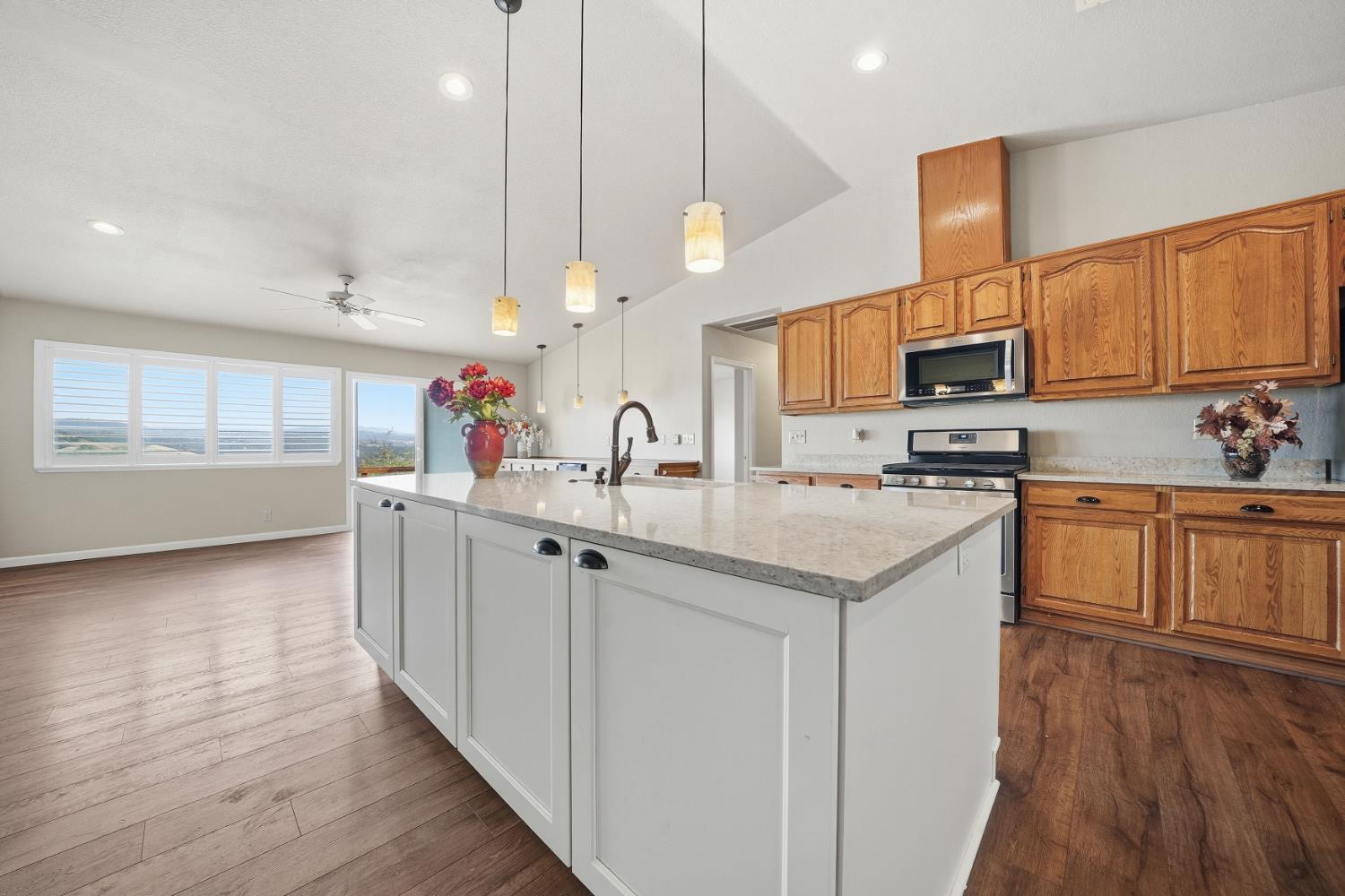 10370 Spunn Road Jackson, CA 95642 - Photo 45 of 87 a kitchen with granite countertop a sink cabinets and wooden floor