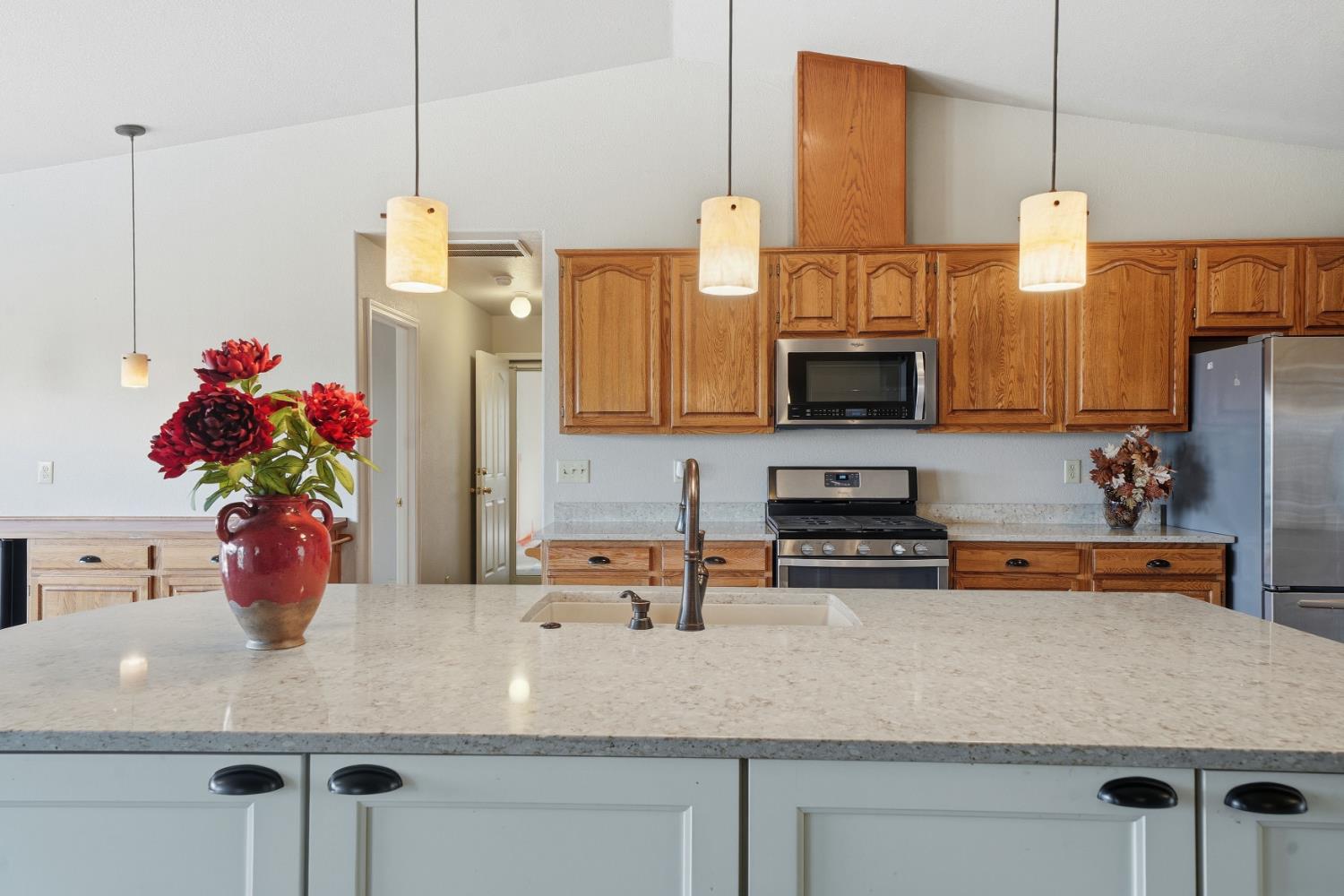 10370 Spunn Road Jackson, CA 95642 - Photo 47 of 87 a kitchen with a sink a microwave a stove and cabinets