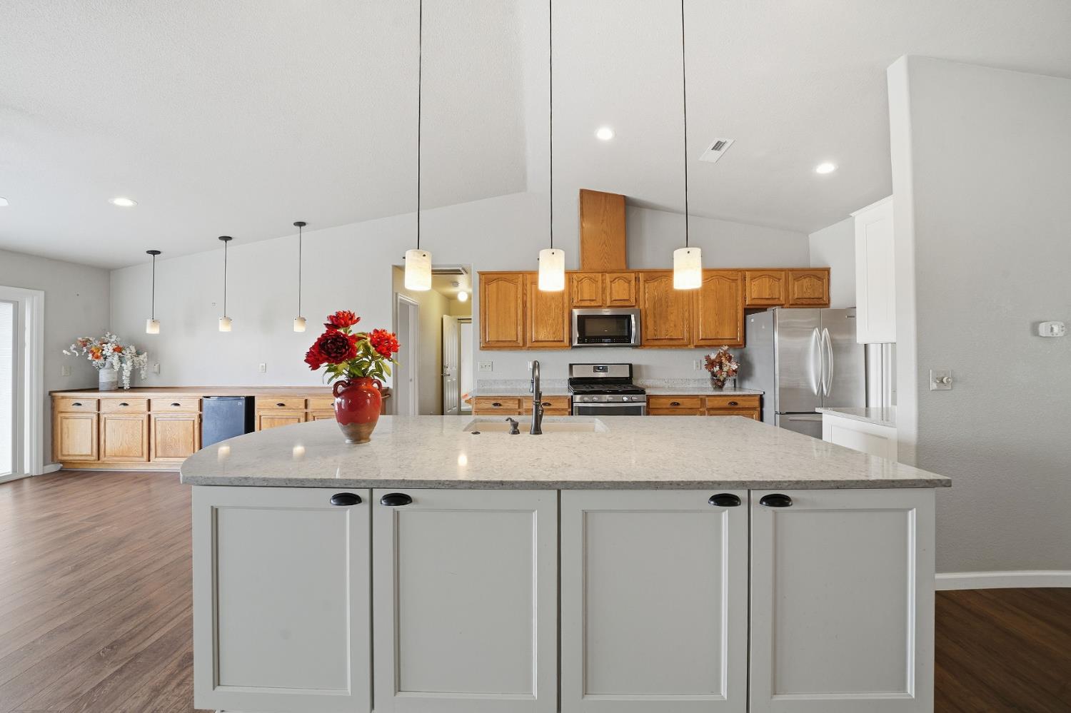 10370 Spunn Road Jackson, CA 95642 - Photo 48 of 87 a kitchen with kitchen island granite countertop a sink cabinets and wooden floor