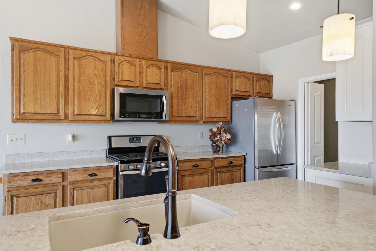 10370 Spunn Road Jackson, CA 95642 - Photo 49 of 87 a kitchen with stainless steel appliances a refrigerator a stove a sink cabinets and a counter space