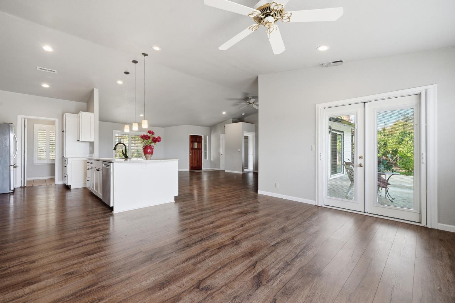 10370 Spunn Road Jackson, CA 95642 - Photo 65 of 87 a view of an empty room with wooden floor and a kitchen