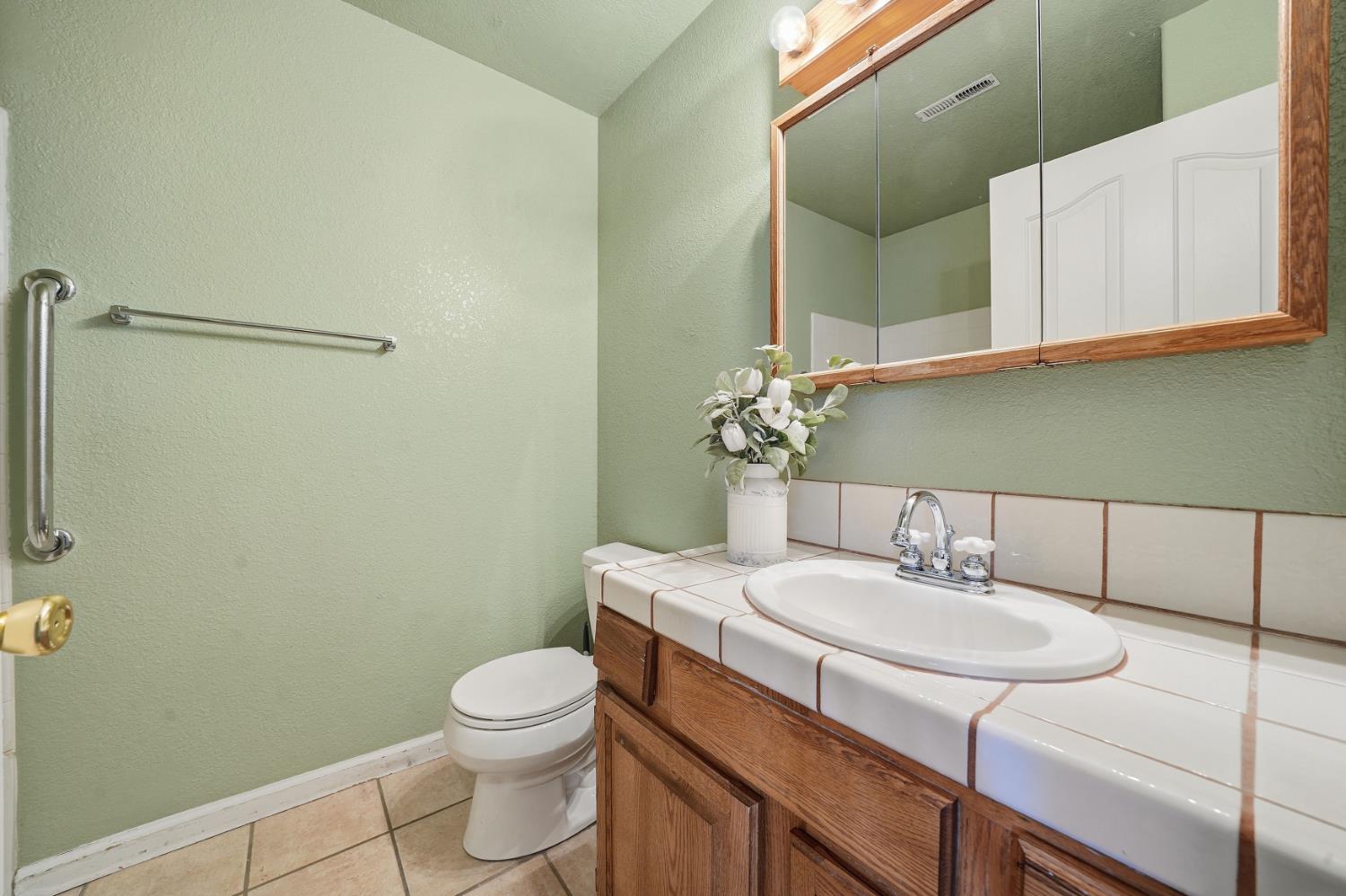 10370 Spunn Road Jackson, CA 95642 - Photo 70 of 87 a bathroom with a sink a toilet and mirror