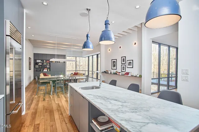 a picture of a living room with a rug and a floor to ceiling window
