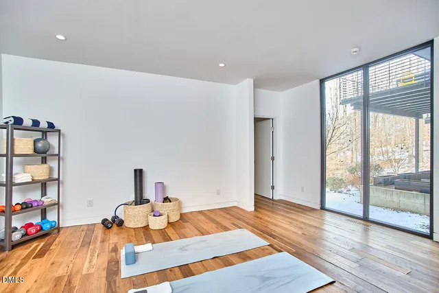 a living room with furniture and a floor to ceiling window