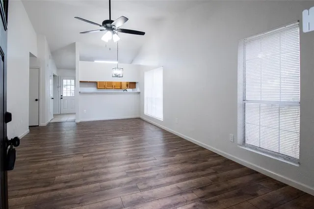 a view of a kitchen with wooden floor and a ceiling fan
