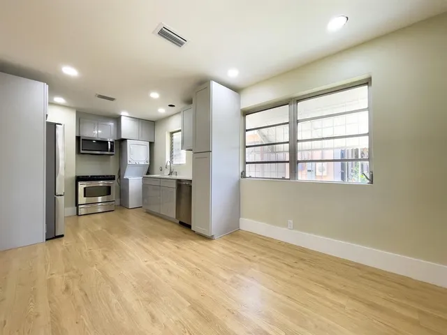 a view of a kitchen with a refrigerator a sink and dishwasher