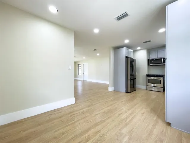 a view of a kitchen with a refrigerator and a stove