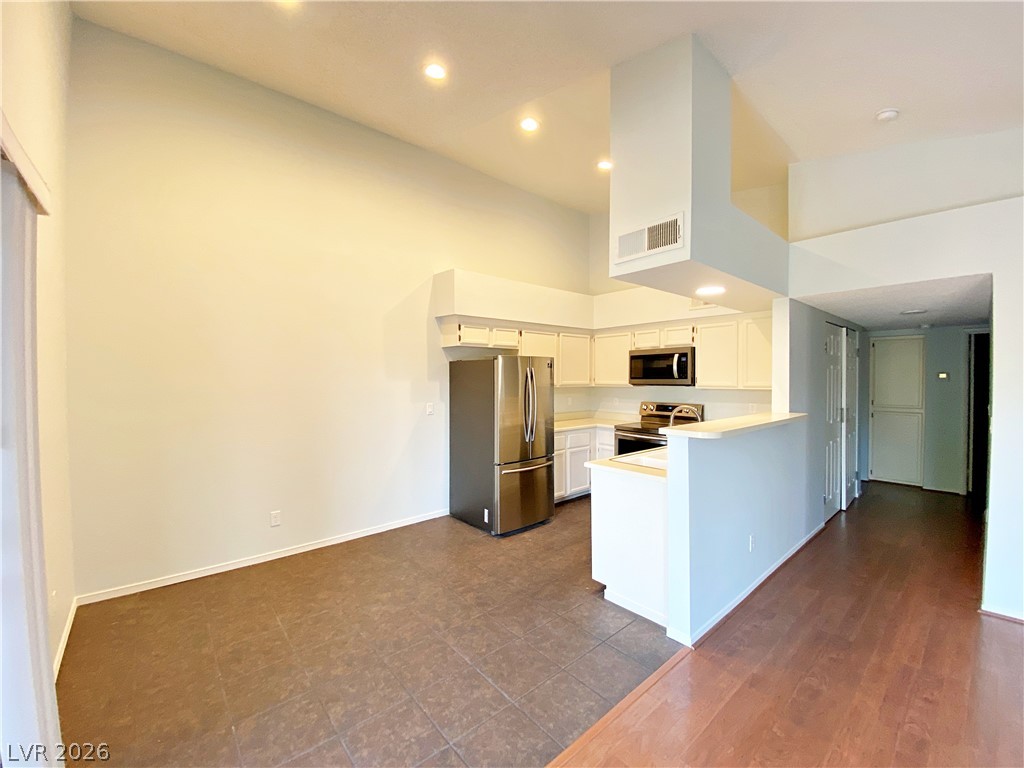 1575 West Warm Springs Road, Unit 1024 Henderson, NV 89014 - Photo 23 of 25 Discover a kitchen featuring stainless steel appliances and crisp white cabinetry, perfect for culinary endeavors.