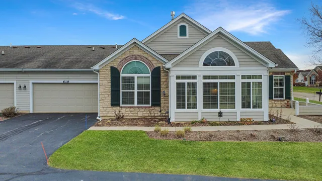 a front view of a house with a yard and outdoor seating