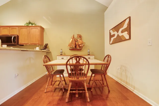 a view of a dining room with furniture and wooden floor