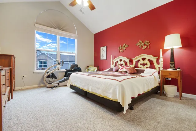 a bedroom with a bed a table and chair