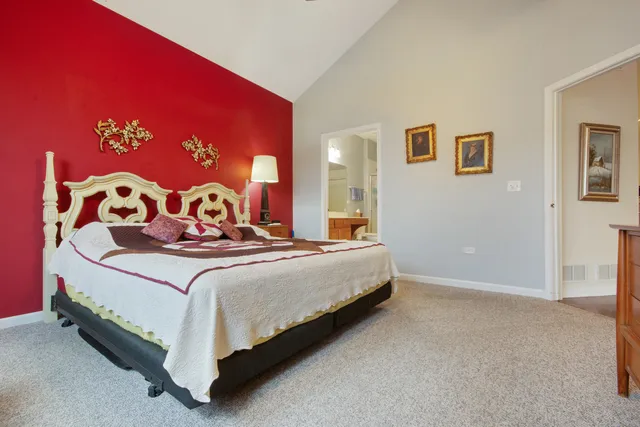 a bedroom with a bed and a wall painting