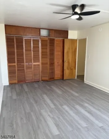 a view of an empty room with a ceiling fan