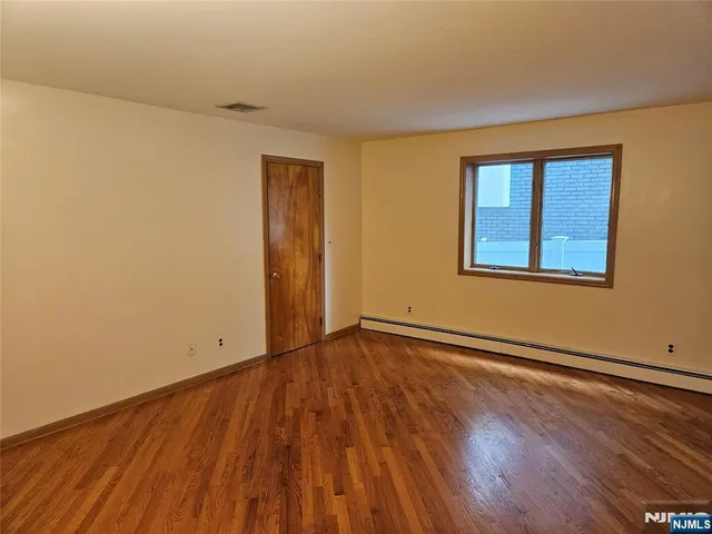 a bathroom with a granite countertop sink a toilet a mirror and shower