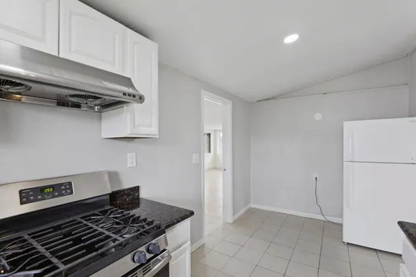 a kitchen with stainless steel appliances granite countertop a stove and a refrigerator