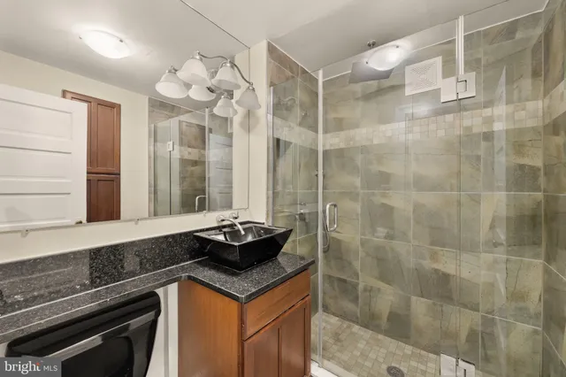 a bathroom with a sink a vanity and a shower