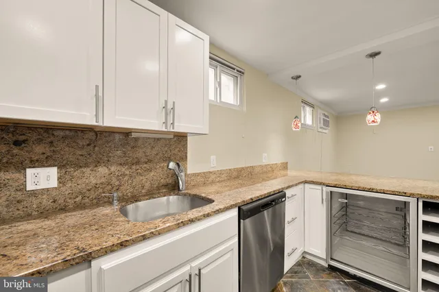 a kitchen that has a sink and a stove
