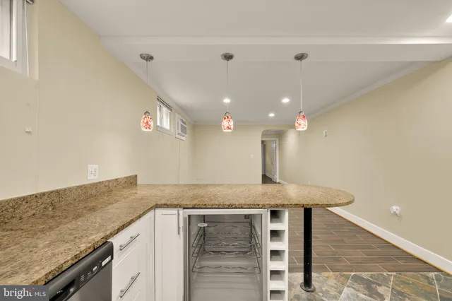 a kitchen with a sink a counter space and a ceiling fan