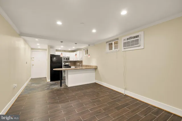 a view of kitchen with stainless steel appliances refrigerator and microwave