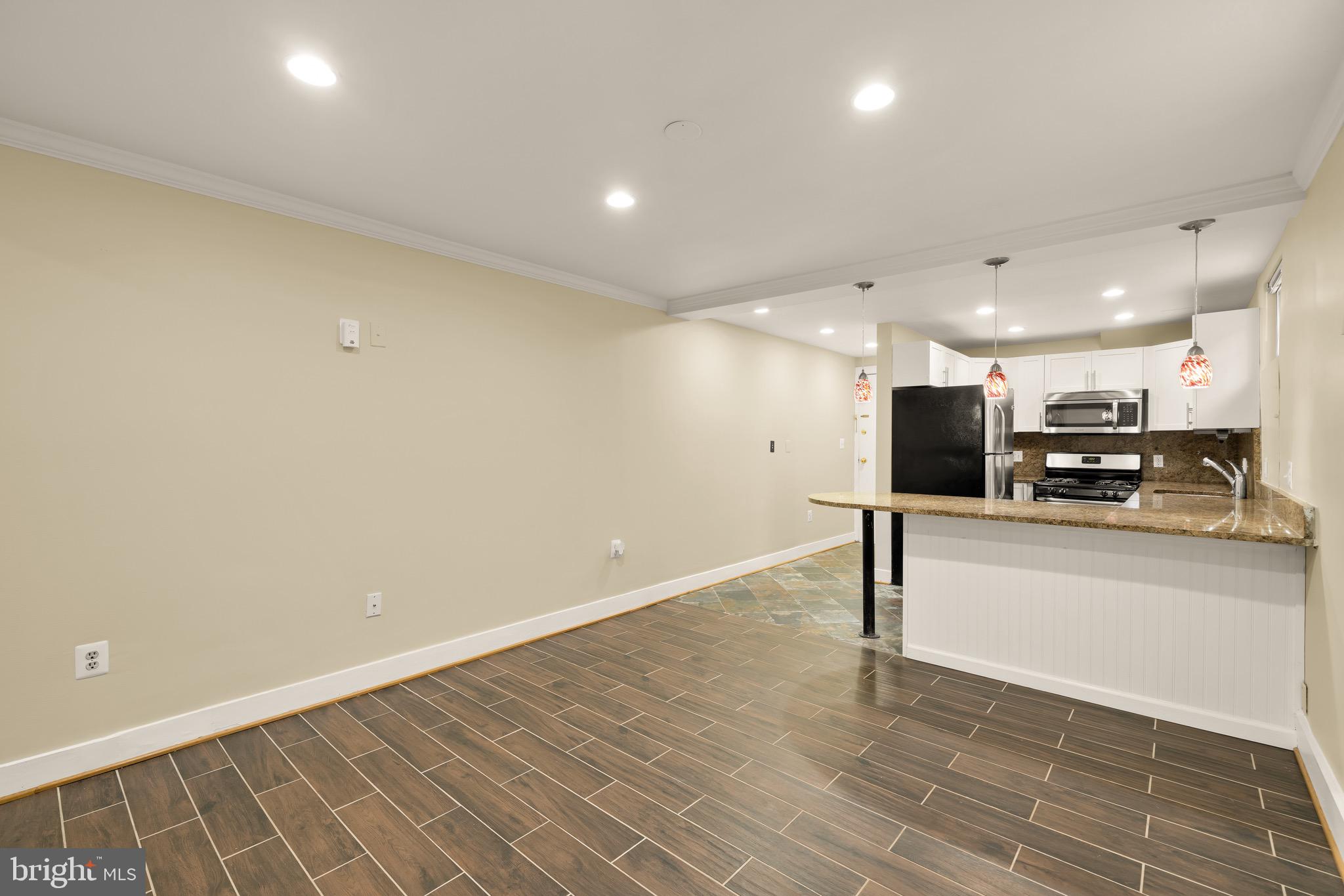 1308 21st Street Northwest, Unit B1 Washington, DC 20036 - Photo 23 of 28 a view of kitchen with stainless steel appliances wooden floor and chair