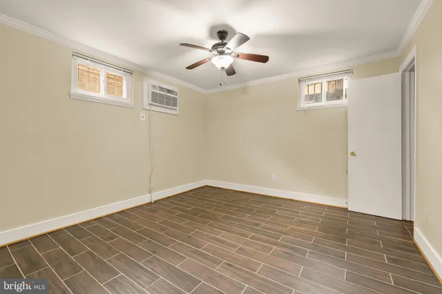a view of an empty room with wooden floor
