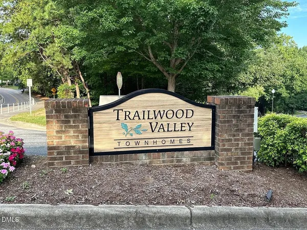 a view of a sign under a tree
