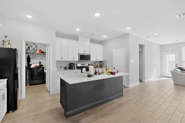 a view of a kitchen with refrigerator cabinets and furniture