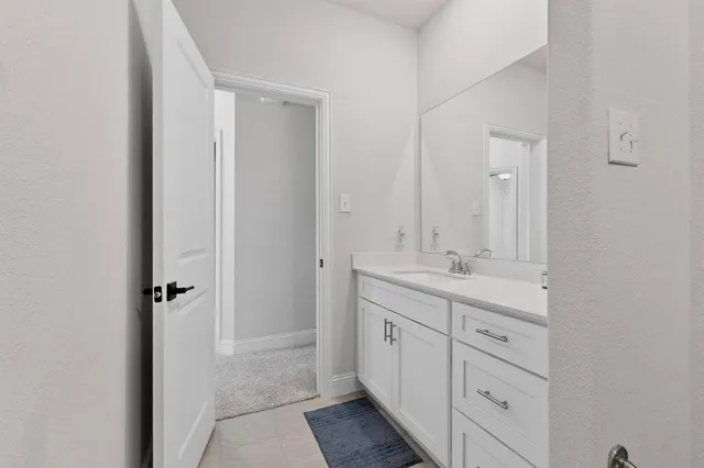a bathroom with a double vanity sink and mirror