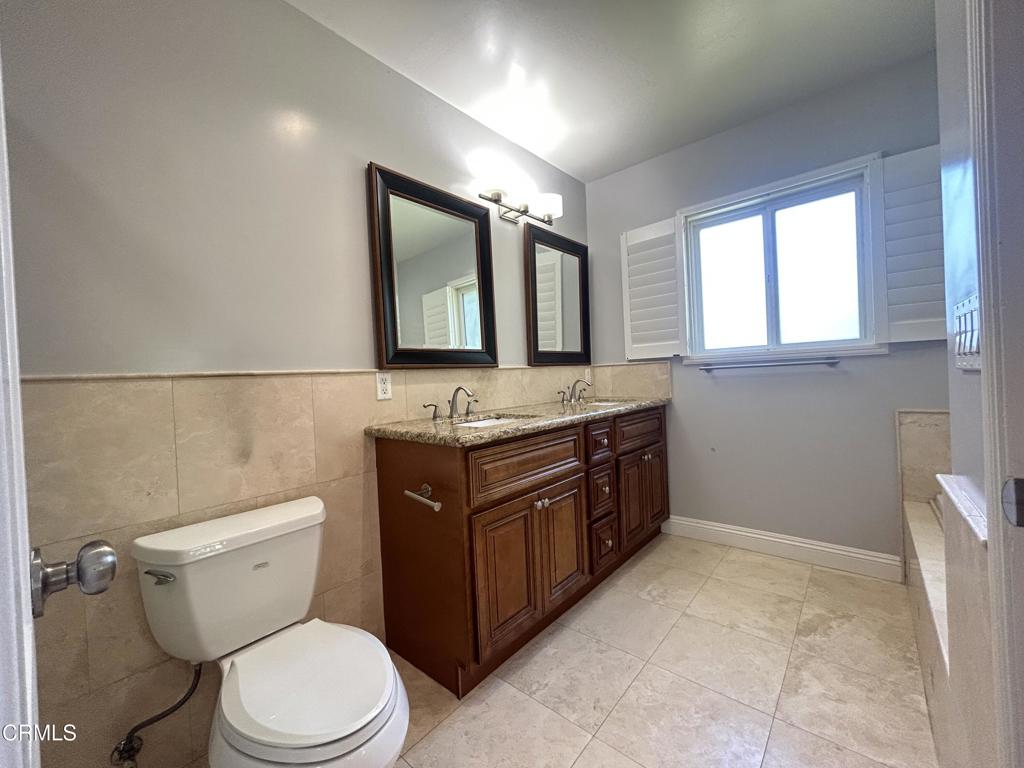 5026 Hook Tree Road La Canada Flintridge, CA 91011 - Photo 15 of 25 a bathroom with a granite countertop toilet sink and mirror