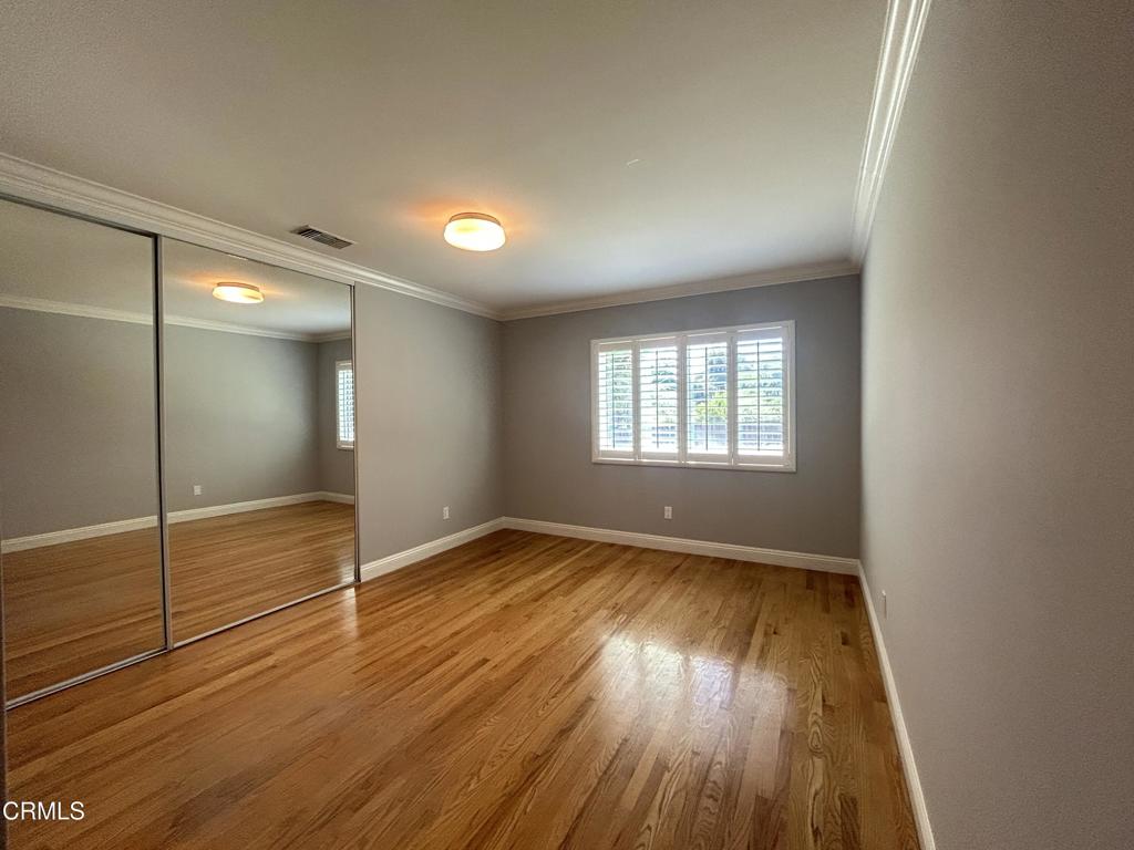 5026 Hook Tree Road La Canada Flintridge, CA 91011 - Photo 18 of 25 an empty room with wooden floor and windows