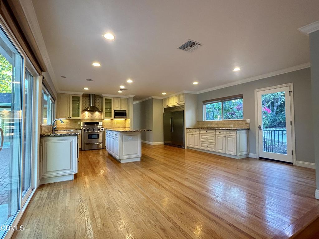 5026 Hook Tree Road La Canada Flintridge, CA 91011 - Photo 6 of 25 a view of a kitchen and dining room with wooden floor