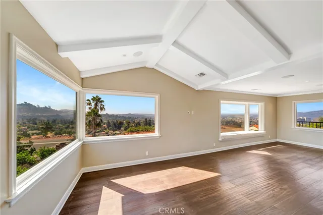 a kitchen with stainless steel appliances wooden floors and large window