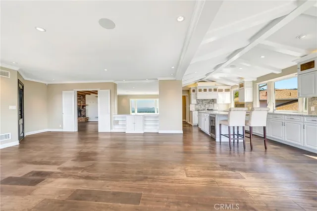 a large white kitchen with a large window